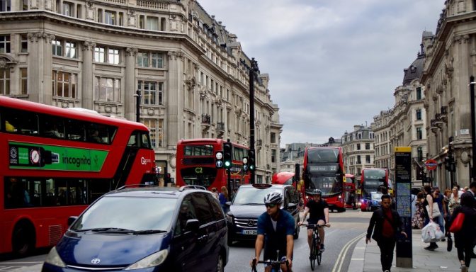 Cyclists, cars and London buses on busy London street