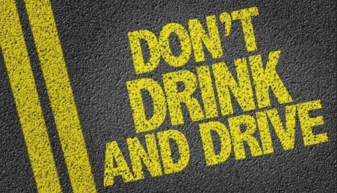 A graphic image showing a road surface with double yellow lines on the left. Text reads: "Don't drink and drive".