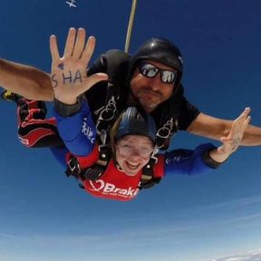Two people taking part in a tandem skydive to fundraise for Brake