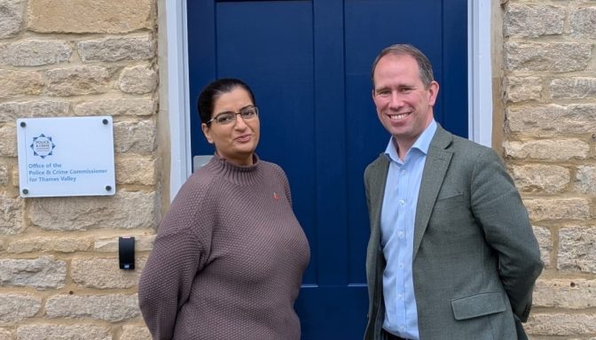 A woman and man pose for a photo outside the Office of the Police and Crime Commissioner for the Thames Valley