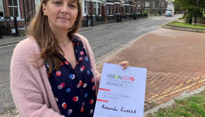 Amanda Russell holding award