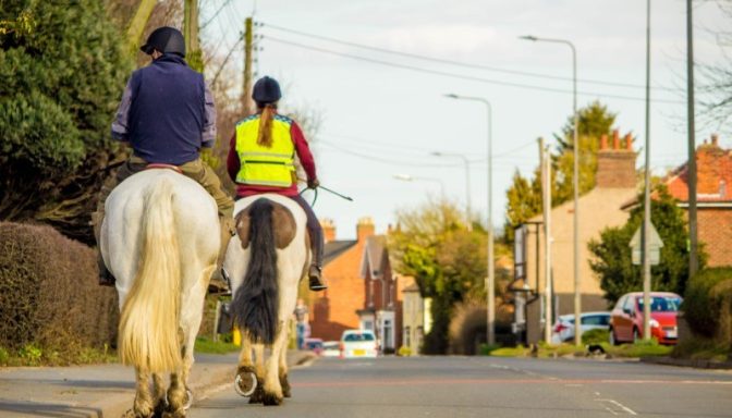 Shutterstock 1054521524 horse riders on road SMALL
