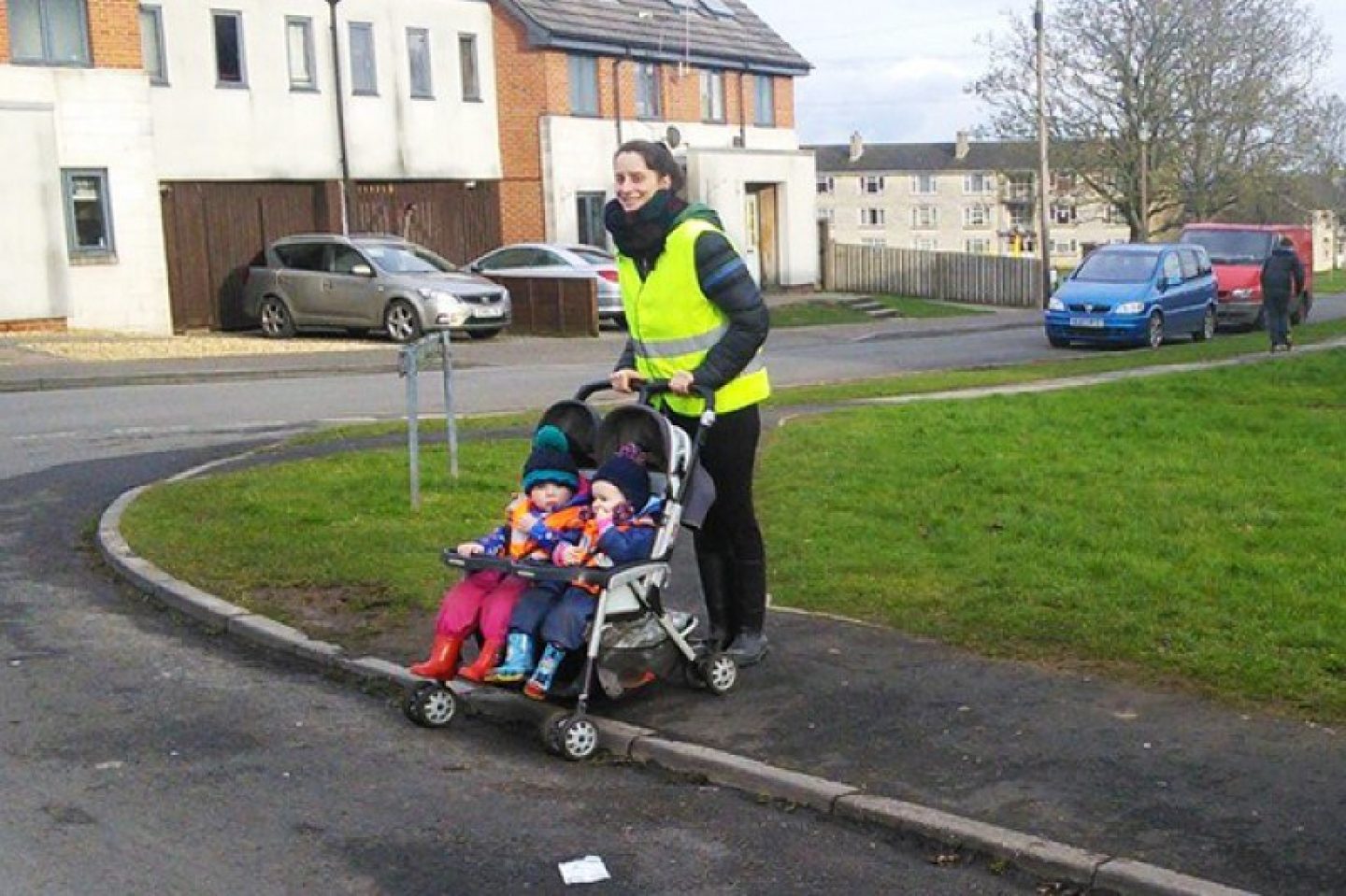 Woman crossing the road with a pushchair